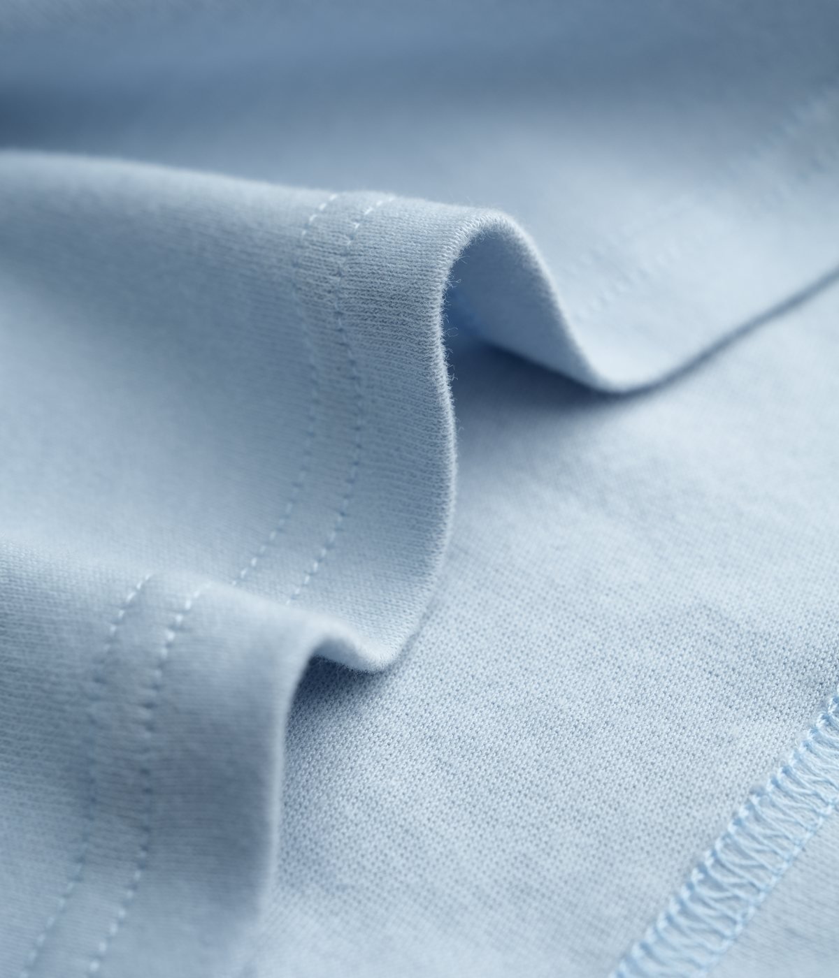 Light blue cotton jersey fabric texture close-up for apparel development