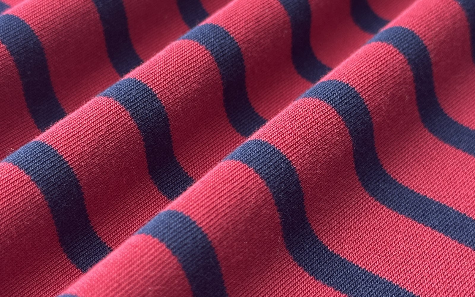 Yarn dyed red and navy stripe jersey fabric close-up